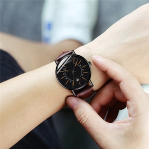 Close-up of Geneva men's quartz watch with black dial and brown leather strap on wrist