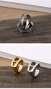 Detail of titanium steel rings featuring zircon inlays and engraved Amazing Grace text
