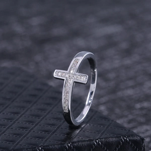 Elegant silver cross ring with micro-pave cubic zirconia on a black leather box