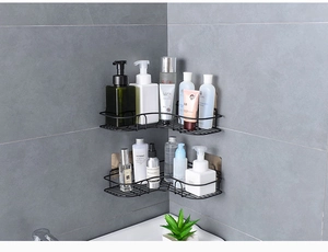 Detail of wall-mounted black metal corner shower caddy set with hollow grid design