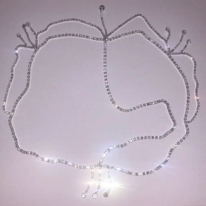 Detail of silver rhinestone hair chain with tassel fringe and floral crown pattern