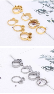 Detailed macro of stainless steel hollow palm and bow rings with pearl accents