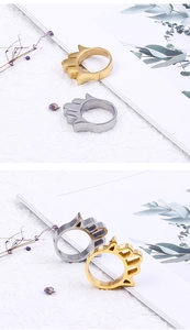 Detail view of gold and silver palm-shaped rings with polished finish and hollow structure