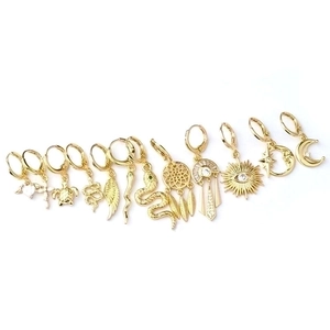 Polished gold snake, cross, and feather charm earrings set for women in minimalist style