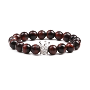 Tiger eye and crown beaded bracelet set with sparkling cubic zirconia on a white background