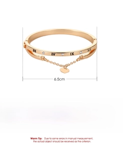 Detail view of a gold roman numeral bracelet showing 6.5cm diameter and 15.49g weight