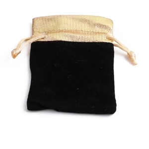 Black velvet drawstring jewelry pouch with a gold silk satin trim for gift packaging