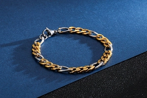 Detail of two-tone gold and silver stainless steel NK chain bracelet with lobster clasp