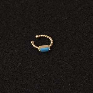 Gold U-shaped ear cuff with beaded metal design and rectangular blue zircon stone