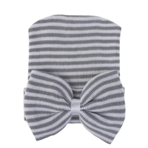 Newborn baby hospital hat with grey and white stripes and a large knitted bow detail