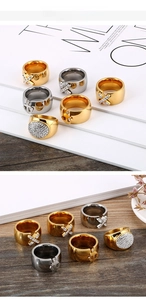 Detailed view of gold and silver anchor rings with crossed diamonds on a rustic background