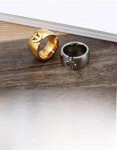 Detail of wide anchor rings in gold and silver steel finishes with sparkling accents