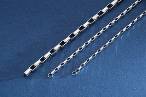 Macro shot of three different widths of polished stainless steel square link chains