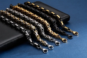 Macro view of assorted stainless steel king chains in silver, gold, and black finishes