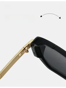 Macro shot of durable golden metal texture hinge on black aviator sunglasses frame