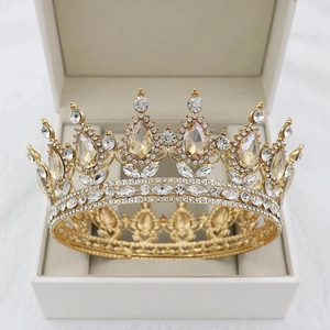 Close-up of golden baroque bridal crown with champagne crystals in a white jewelry box