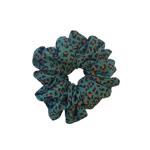 Oversized dark green leopard print scrunchie with orange and black spots for vintage hair styling