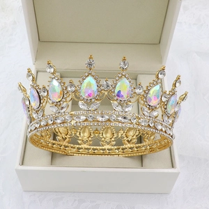 Baroque gold bridal crown with crystal teardrop stones inside a beige jewelry gift box