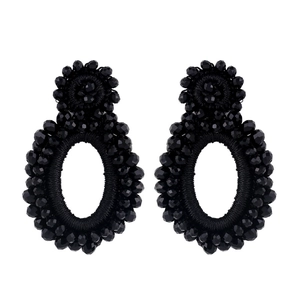 Macro shot of black faceted bead embroidery on vintage bohemian oval drop earrings