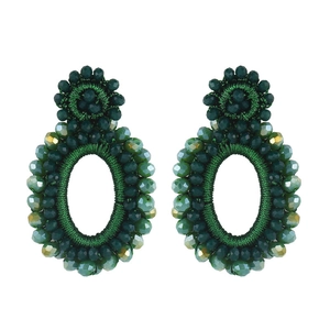 Macro shot of dark green beaded hoop earrings with bohemian hand-woven crystal details