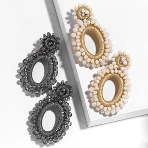 Bohemian beaded hoop earrings in dark grey and cream white with intricate weaving
