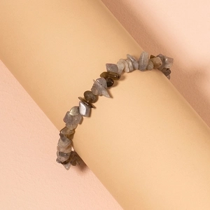 Bohemian irregular turquoise stone bracelet on soft pink minimalist display stand