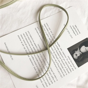 Detailed close-up of bean green faux leather shoulder strap with precise tonal stitching