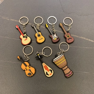 Close-up of a 7-piece musical instrument keychain set in colorful PVC soft rubber