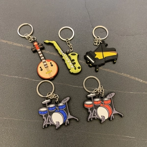 Detail of 5 colorful PVC musical instrument charms including piano and drums with keyrings