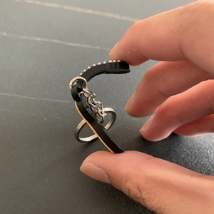 Close-up showing the high flexibility of the durable PVC guitar keychain under pressure