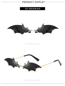 Close-up of gold-framed bat-shaped sunglasses with black lenses and metal temples