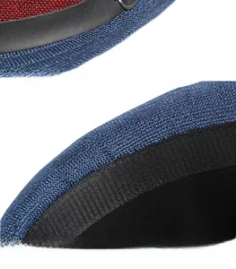 Detail of red and blue woven fedora featuring black leather band and silver buckle