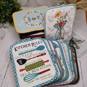 Detailed view of quilted cotton heat insulation pads with bee and floral patterns