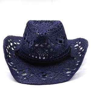 Detail of navy blue hand-woven cowboy straw hat featuring hollow-out crochet pattern