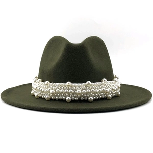 Detailed texture of dark green wool felt hat with decorative white pearl band