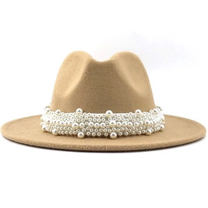 Close-up of khaki wool fedora hat featuring elegant white pearl band embellishment