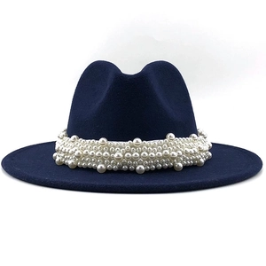 Detail of elegant navy wool fedora hat featuring multi-layer white pearl embellishments