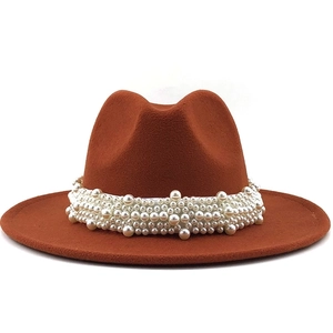 Detail of elegant brown felt fedora featuring multi-layer pearl bead embellishments