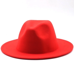 Detail view of red wide brim felt fedora hat featuring classic top crease and structured shape