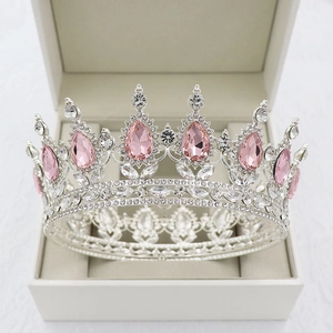 Detailed view of a silver bridal crown featuring pink teardrop gems in a jewelry box