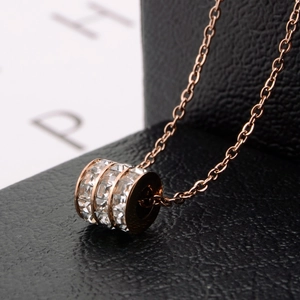 Rose gold cylinder pendant necklace with three rows of sparkling crystals on black leather