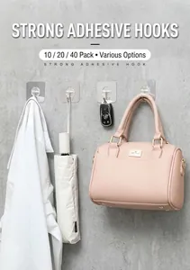 Strong transparent adhesive wall hooks holding heavy bags and keys on a wooden surface