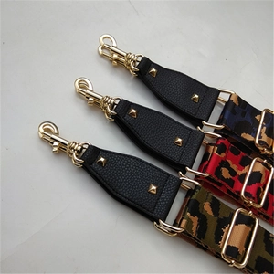 Detail of leopard print bag straps with gold rivets and lobster clasps in three colors