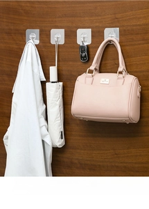 Transparent adhesive wall hooks showing multi-use storage for keys, bags and umbrellas