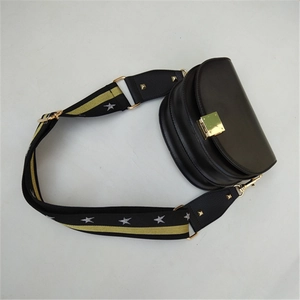 Close-up of adjustable leopard print bag strap with gold buckles and star patterns