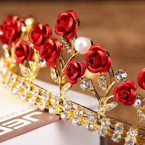 Exquisite golden bridal crown with red roses, white pearls and sparkling rhinestones