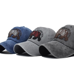 Three washed cotton baseball caps with bear embroidery in navy, light gray, and dark gray