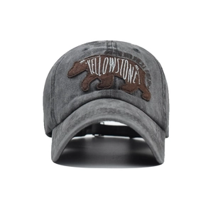Close-up of Yellowstone bear embroidery on a vintage washed dark gray cotton baseball cap