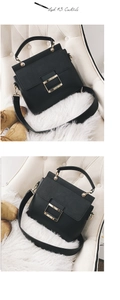 Detail of black crossbody bag with litchi texture and golden square metal buckle