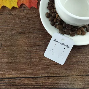 Vertical white textured jewelry card for earrings with Fashion Jewelry text on wood